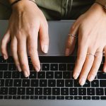 crop unrecognizable woman working on laptop